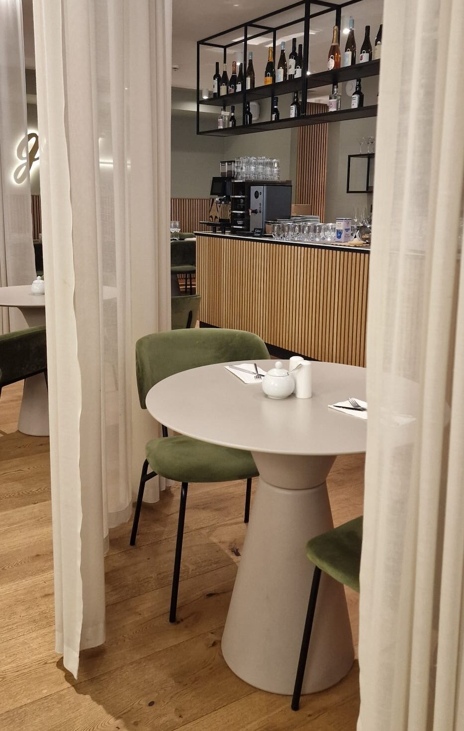 Tisch im Frühstücksraum Hotel Atlantic Juist mit Gardinen zwischen den Tischen